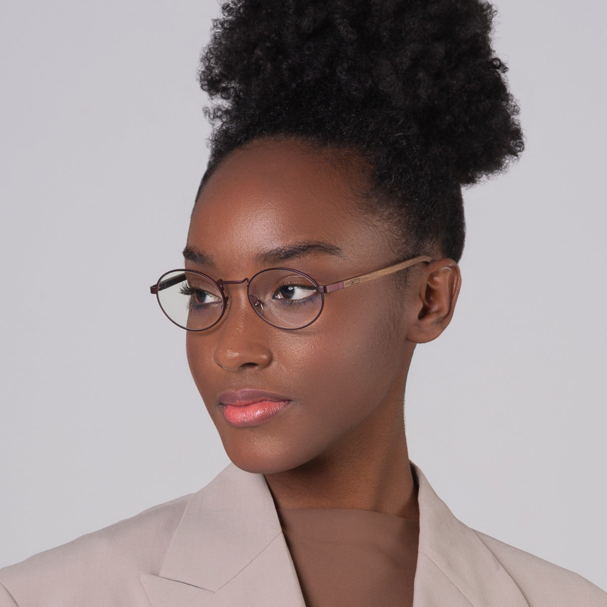 Armação de metal oval vinho em modelo com rosto pequeno.